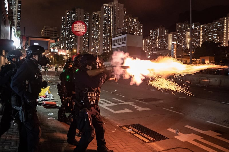 HONG KONG, CHINA - AUGUST 5: Riot police fire tear gas at protesters during a demonstration in Wong Tai Sin District on August 5, 2019 in Hong Kong, China. Pro-democracy protesters have continued rallies on the streets of Hong Kong against a controversial extradition bill since 9 June as the city plunged into crisis after waves of demonstrations and several violent clashes. Hong Kong's Chief Executive Carrie Lam apologized for introducing the bill and declared it "dead", however protesters have continued to draw large crowds with demands for Lam's resignation and completely withdraw the bill. (Photo by Anthony Kwan/Getty Images) *** BESTPIX ***