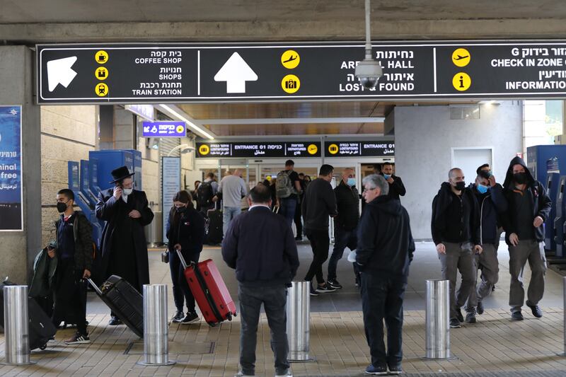 Passengers walk through the arrivals hall of Ben Gurion International Airport near Tel Aviv on January 9, 2022, after Israel opened its borders to vaccinated tourists. EPA