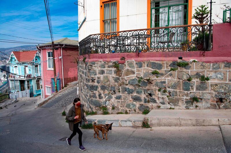 A woman and her dog walk up a hill since elevators are currently out of operation. AFP