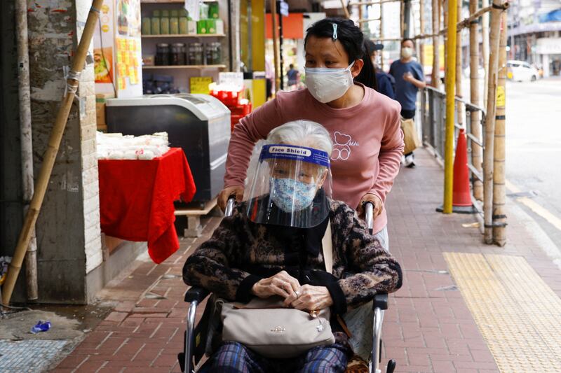 An elderly woman wears a protective mask and face shield in Hong Kong. Photo: Reuters