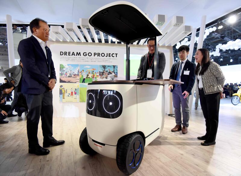 Journalists try Honda's RoboCas Concept, an electric cart with autonomous drive function. Toru Yamanaka/AFP