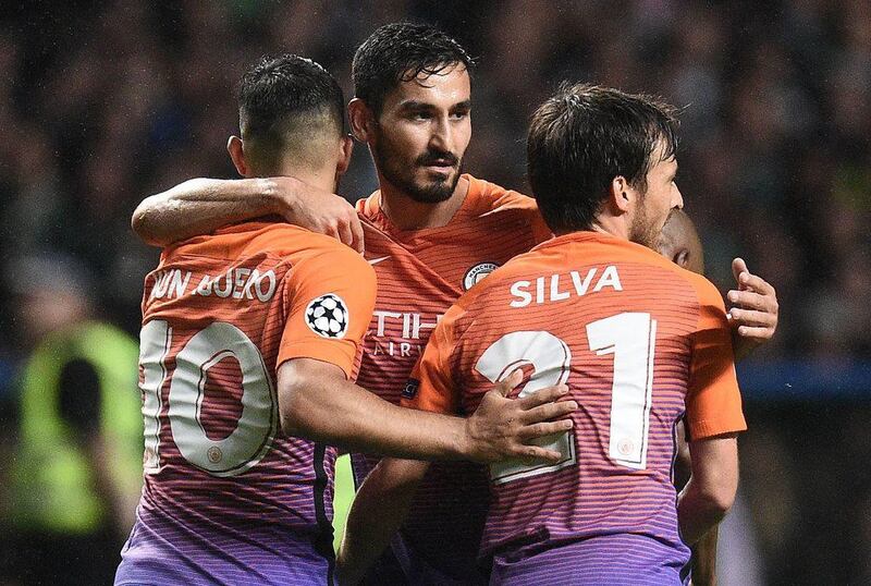 Manchester City’s Sergio Aguero, left, Ilkay Gundogan, centre, and David Silva celebrate the equalising third goal. Oli Scarff / AFP