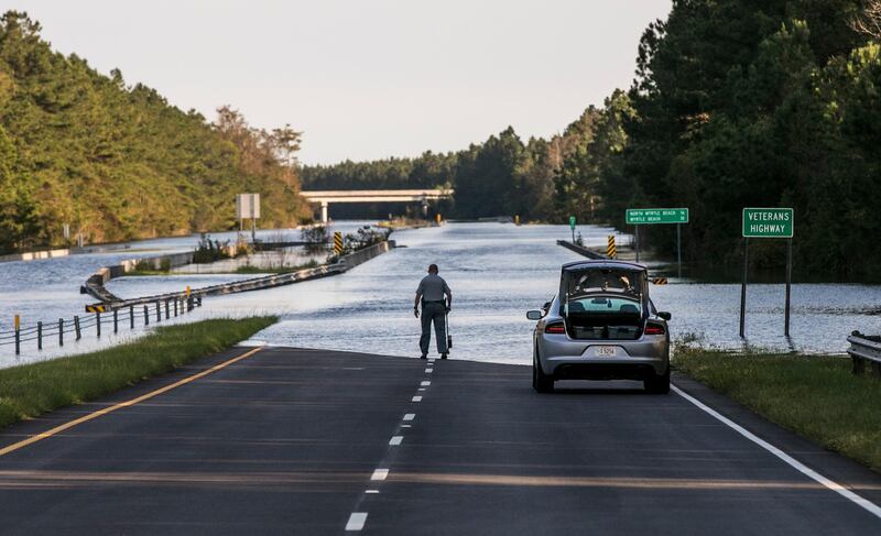 A flooded Highway 22 in Conway, South Carolina. The blocked road has traffic snarled around Conway and the Waccamaw River continues to rise past record levels. Jason Lee/AP Photo