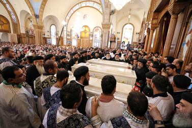 Relatives of the victims, who were killed by gunmen during an ambush while travelling in three buses carrying Coptic Christians to a remote desert monastery in Egypt's southern Minya province, react during their funeral in Sawada village, near Minya. EPA