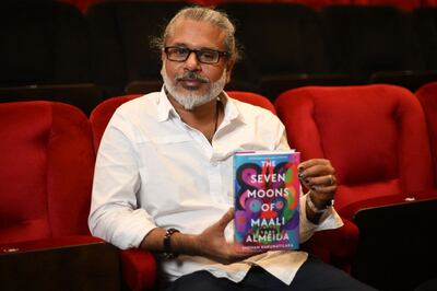 Sri Lankan author Shehan Karunatilaka holds his book 'The Seven Moons of Maali Almeida' at the Shaw Theatre in King's Cross in London on October 14 before Monday's announcement of his Booker Prize for Fiction. AFP