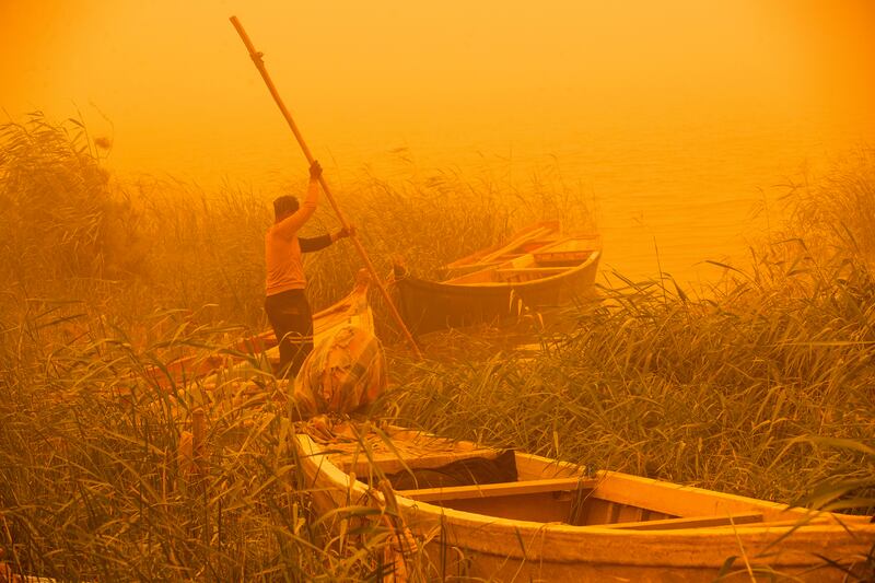 A fisherman sails his boat on the Shatt Al Arab during a sandstorm in Basra, Iraq. AP Photo