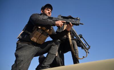 Iraqis carry firearms near the Iraqi-Syrian border. AFP