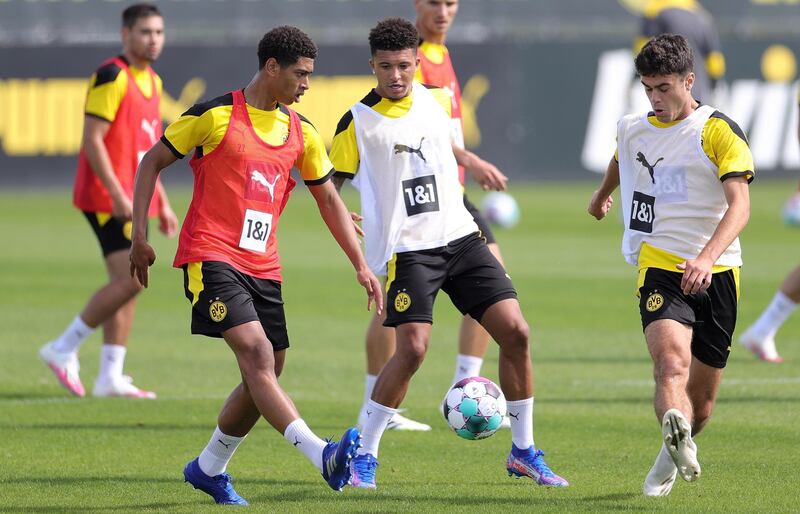 Dortmund's Jude Bellingham, left, and Jadon Sancho, centre, attend the team's pre-season training session. EPA