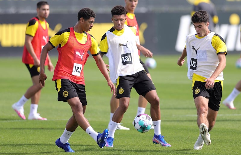 Dortmund's Jude Bellingham, left, and Jadon Sancho, centre, attend the team's pre-season training session. EPA