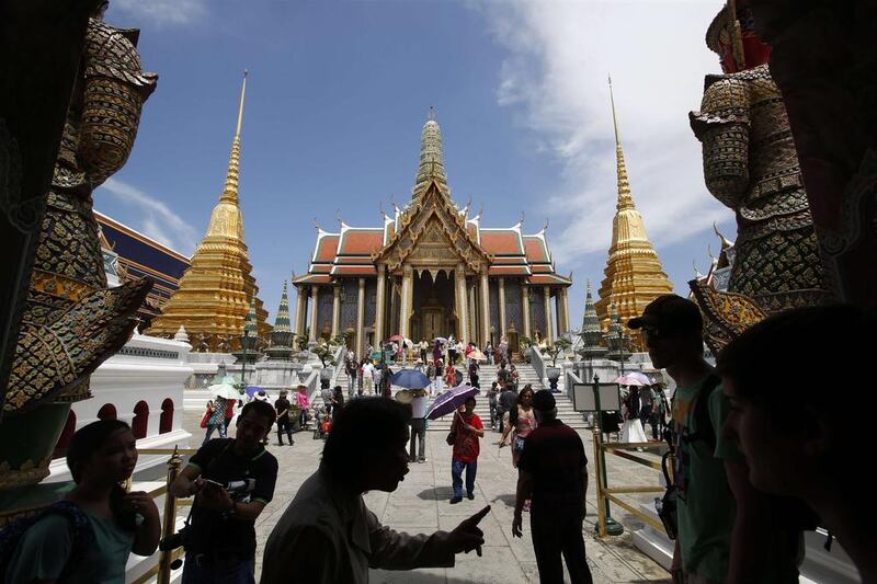 Tourists visit the Grand Palace in Bangkok. The Thai army's imposition of martial law is another blow to the country's tourist industry, adding to the economic pain from six months of destabilising street protests. REUTERS/Erik De Castro 