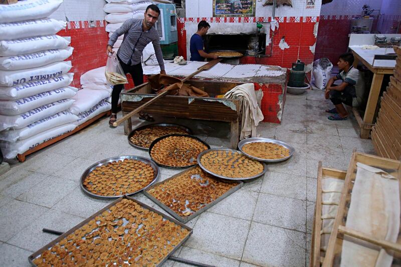 People gather at a bakery in Baghdad, Iraq. AP Photo