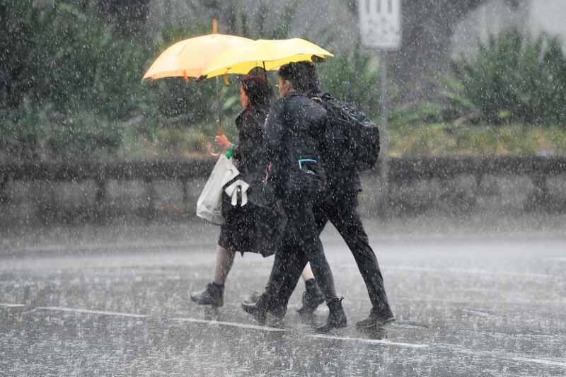 Pedestrians hold umbrellas as they walk in heavy rain in Sydney's CBD, Australia. REUTERS