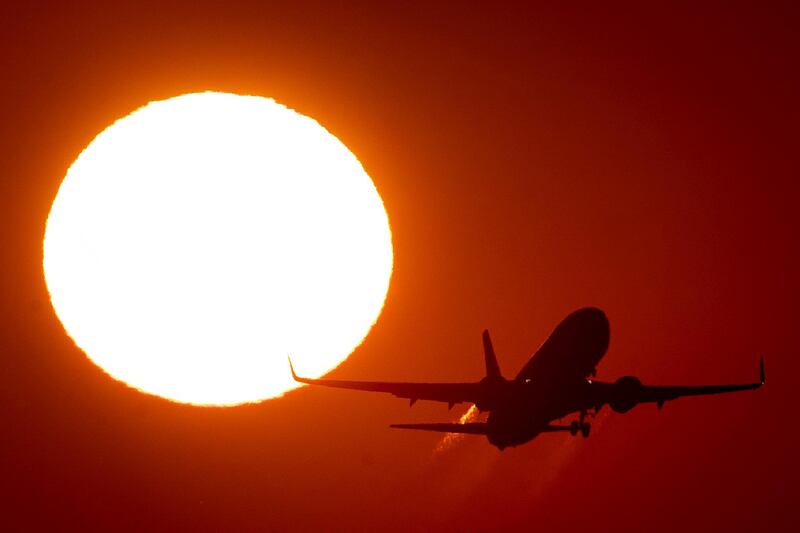 An aircraft takes off the runway as the sun rises in Frankfurt, Germany. AP Photo