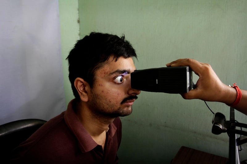 FILE- In this May 16, 2012 file photo, an Indian man gets his retina scanned as he enrolls for Aadhar, India's unique identification project in Kolkata, India. India's top court has upheld the government's policy of issuing a 12-digit identification number to every Indian, but says it can't be made mandatory for services such as bank accounts, cellphone connections or school admissions.(AP Photo/Bikas Das, File)