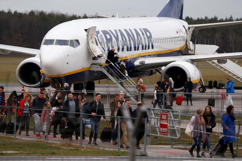 People walk on the tarmac as they leave a Ryanair aircraft at the airport in Modlin near Warsaw, Poland November 15, 2018. Picture taken November 15, 2018. REUTERS/Kacper Pempel