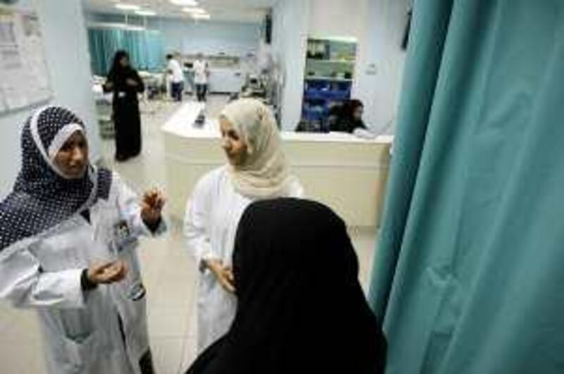 DUBAI, UNITED ARAB EMIRATES Ð July 9: Left to Right- Dr.Essaf Barahma and Dr. Moaza Al Hattawi from breast cancer team talking to one of the breast cancer patient at Rashid Hospital in Dubai. (Pawan Singh / The National) For News. Story by Nour
 *** Local Caption ***  PS05- BREAST CANCER.jpg