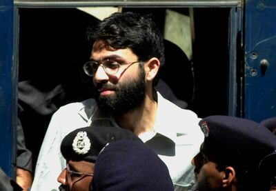 FILE- In this March 29, 2002 file photo, Ahmed Omar Saeed Sheikh, the alleged mastermind behind Wall Street Journal reporter Daniel Pearl's kidnap-slaying, appears at the court in Karachi, Pakistan. On Thursday, Dec. 24, 2020, a provincial court in Pakistan overturned a Supreme Court Decision that Sheikh should remain in custody during an appeal of his acquittal on charges he murdered Pearl. (AP Photo/Zia Mazhar, File)