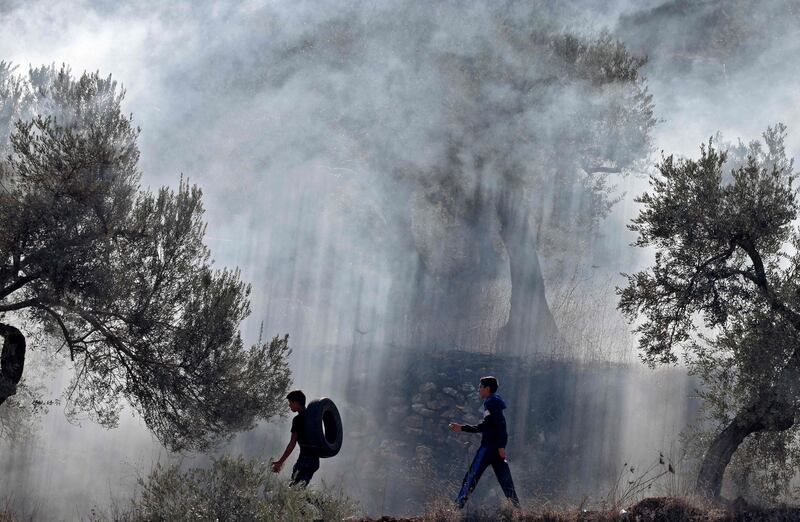 Palestinians burn tyres during a protest against the resumption of construction at the settlement of Eviatar near the Palestinian village of Beita, south of Nablus in the occupied West Bank. AFP
