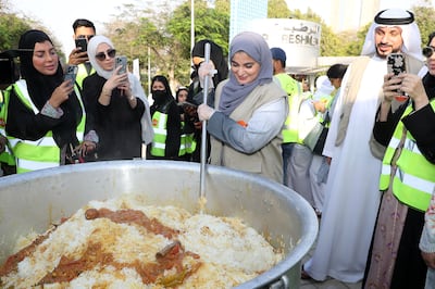 Manal Bin Yaroof, head of the UAE Food Bank executive team, helps to prepare biryani for iftar. Pawan Singh / The National