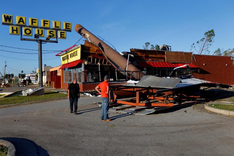 People inspect a Waffle House damaged by Hurricane Michael in Callaway, Florida. Reuters
