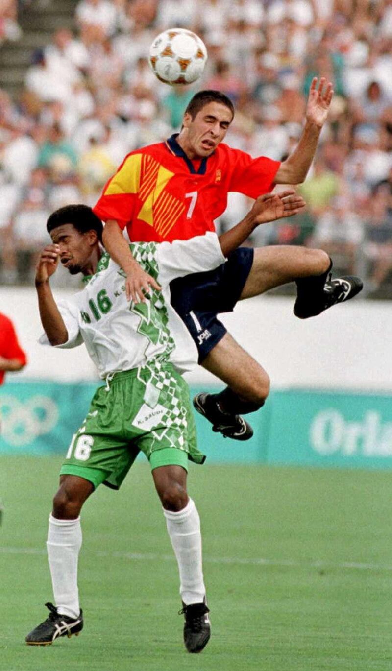 Spain's Raul Blanco Gonzalez (R) collides with Saudi Arabia's Khamis Al-Dossari  as he goes for a header during the first half of their Olympic soccer Group B match at the Florida Citrus Bowl in Orlando, Florida, 20 July. Spain won the game 1-0.
            AFP PHOTO/David MILLS (Photo by David MILLS / AFP)