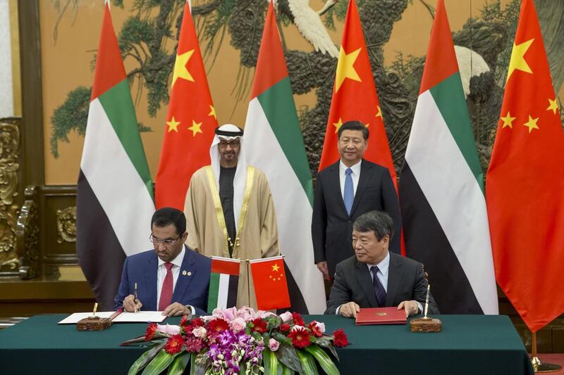 Sheikh Mohammed bin Zayed, Crown Prince of Abu Dhabi and Deputy Supreme Commander of the Armed Forces and Xi Jinping, President of China witness the signing of a memorandum of understanding between the UAE State Minister’s Office and the National Committee for Development and Reforms (NDRC) of China pertaining to a $10 billion joint strategic investment fund. Seen signing on behalf of the UAE at the Great Hall of the People is Dr Sultan Al Jaber, Minister of State Chairman of Masdar and Chairman of the Abu Dhabi Ports Company (ADPC) (L), during a state visit to China. Ryan Carter / Crown Prince Court - Abu Dhabi