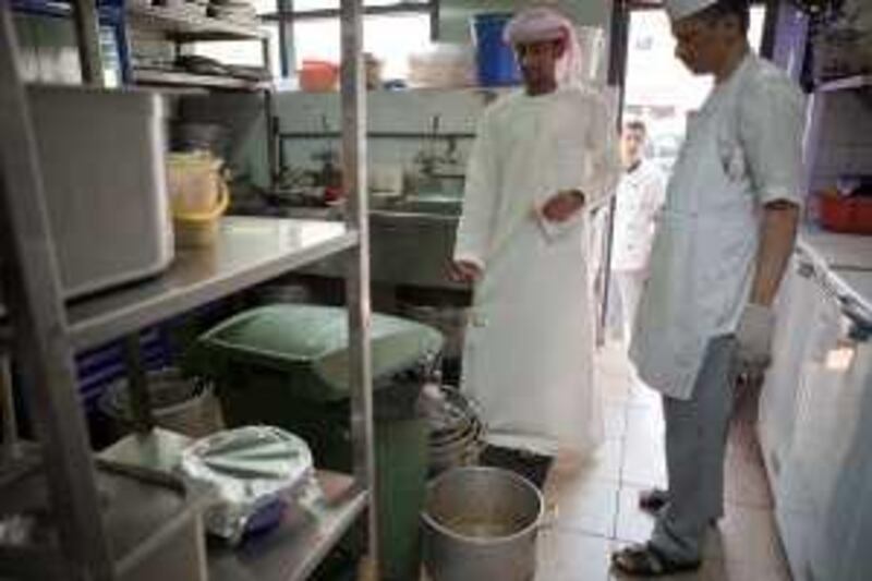 ABU DHABI,UAE. April 18, 2010. An inspector from the Abu Dhabi Food Control Authority carrying out an inspection on a restaurant's kitchen facilities.
