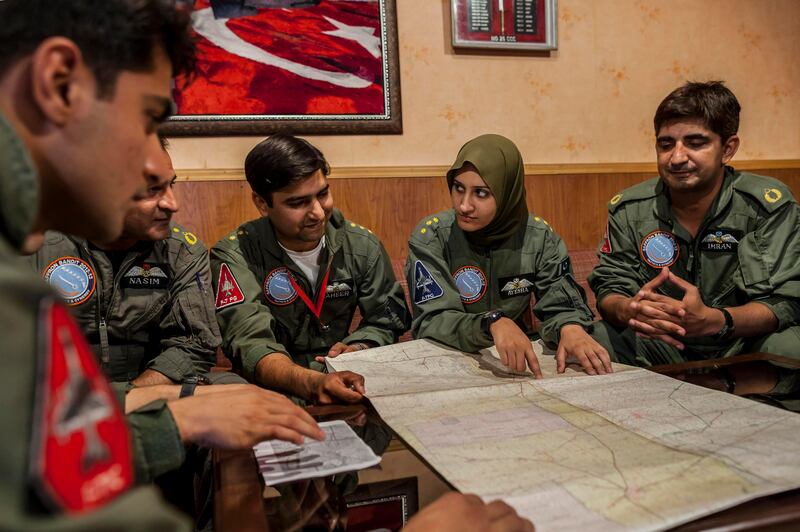 Ayesha Farooq, 26, (2nd R) Pakistan's only female war-ready fighter pilot, attends a briefing with colleagues at Mushaf base in Sargodha, north Pakistan June 6, 2013. Farooq, from Punjab province's historic city of Bahawalpur, is one of 19 women who have become pilots in the Pakistan Air Force over the last decade - there are five other female fighter pilots, but they have yet to take the final tests to qualify for combat. A growing number of women have joined Pakistan's defence forces in recent years as attitudes towards women change. Picture taken June 6, 2013.  REUTERS/Zohra Bensemra (PAKISTAN - Tags: MILITARY SOCIETY) *** Local Caption ***  ZOH07_PAKISTAN-AIRF_0612_11.JPG