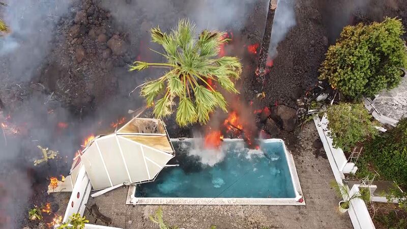 Hot lava reaches a swimming pool on the island of La Palma. AP Photo