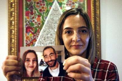 In this July 30, 2019, photo, Aya Al-Umari, whose brother Hussein was killed in the Christchurch mosque attacks, poses holding a photo of herself and her brother, in Christchurch, New Zealand. She is among 200 survivors and relatives from the Christchurch mosque shootings who are traveling to Saudi Arabia as guests of King Salman for the Hajj pilgrimage, a trip many hope will help them to heal.(AP Photo/Nick Perry)