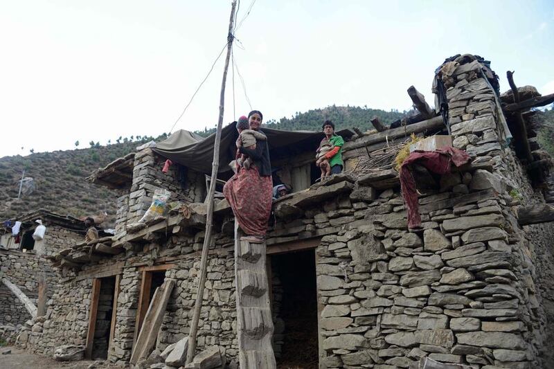 Dana Sunar, 18, a member of the Dalit caste, holds one of her children on a rooftop in Simikot, Humla district, some 430 kms north-west of Kathmandu. More than one in three girls in Nepal marry before they reach the age of 18, according to Human Rights Watch, even though child marriage is illegal in the country. Prakash Mathema / file, Agence France-Presse 