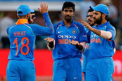 India bowler Jasprit Bumrah (C) is celebrated for a dismissal during the fifth One Day International cricket match between South Africa and India at Saint George Park, in Port Elizabeth, on February 13, 2018. / AFP PHOTO / MARCO LONGARI