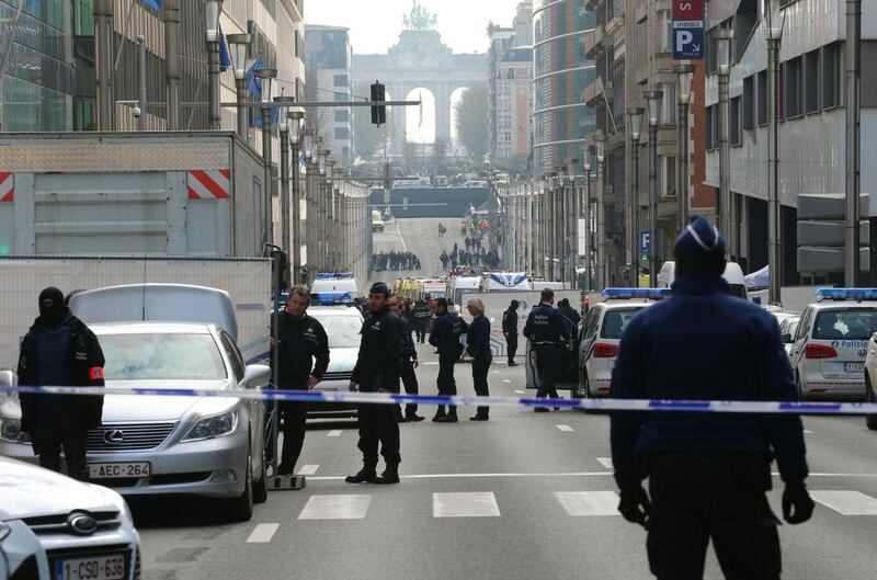 Policemen stand guard near a security perimeter set in the Rue de la Loi near the Maalbeek subway station, in Brussels, after an explosion killed around 10 people, according to spokesman of Brussels' fire brigade. Nicolas Maeterlinck / AFP / Belga