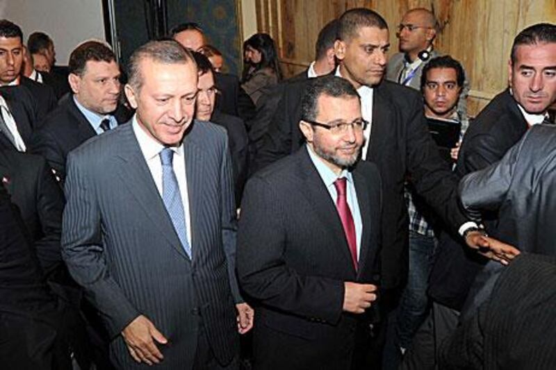 Hisham Qandil, the Egypt prime minister, centre, and his Turkish counterpart Recep Tayyip Erdogan meet in Cairo today.