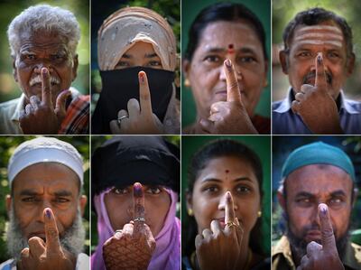 Voters show their indelible ink marks at a polling station during the Karnataka state assembly election in Bengaluru. AFP