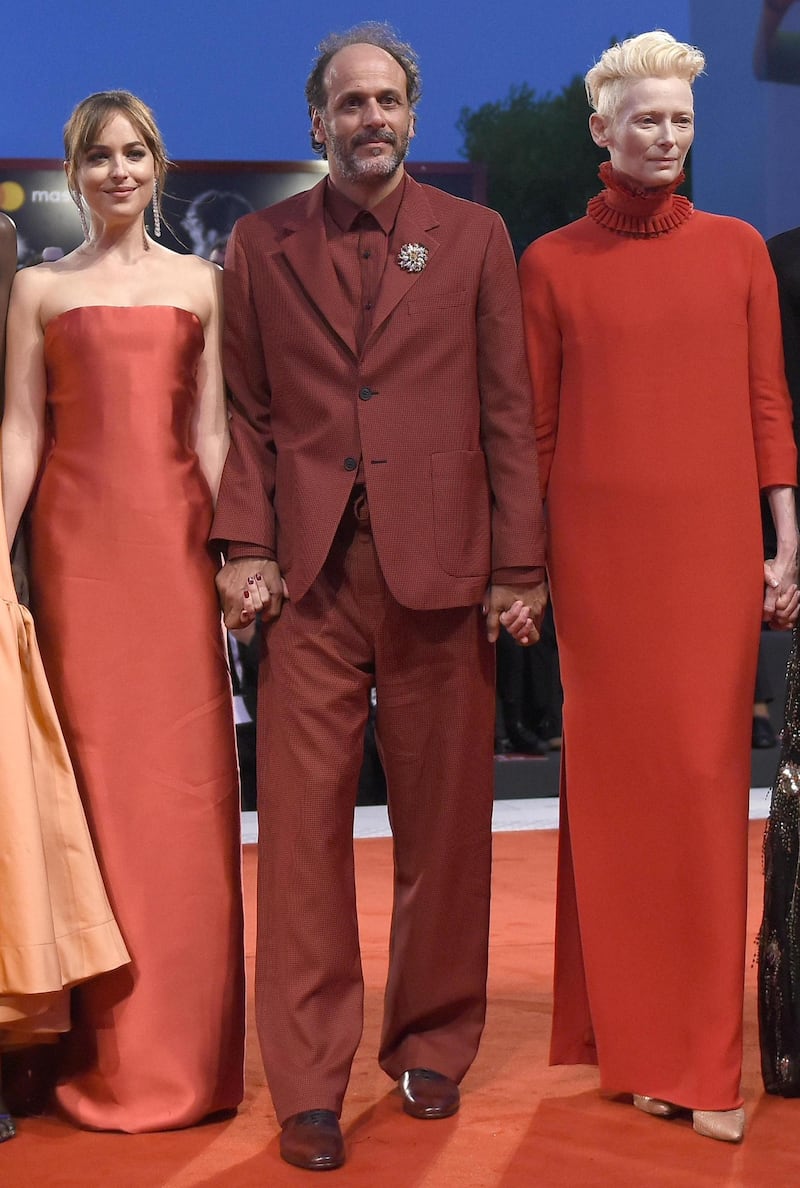 epa06991065 (L-R) US actress Dakota Johnson, Italian film director Luca Guadagnino and British actress Tilda Swinton arrive for the premiere of 'Suspiria' during the 75th annual Venice International Film Festival, in Venice, Italy, 01 September 2018. The movie is presented in the official competition 'Venezia 75' at the festival running from 29 August to 08 September 2018.  EPA/CLAUDIO ONORATI