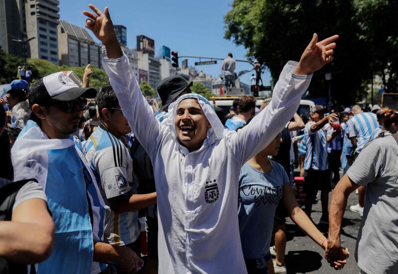 Fans wait for the bus with Argentina's World Cup winners in Buenos Aires on December 20, 2022. AFP