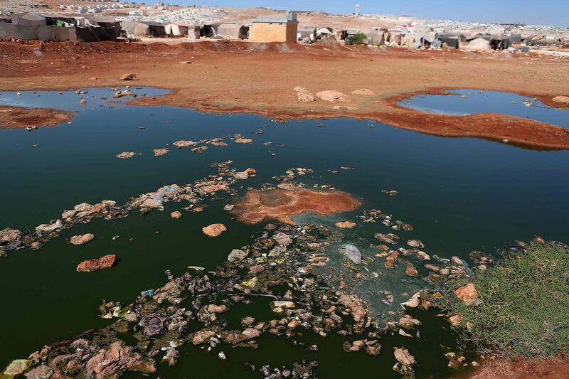 A puddle of contaminated water at a camp for internally displaced people in the town of Sarmada, in Syria's north-western Idlib province, in September 2022. Cholera is generally contracted from contaminated food or water and spreads in residential areas that lack proper sewerage networks or mains drinking water. AFP