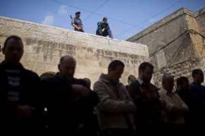 Palestinian men, foreground in silhouette, who were prevented from reaching the Al-Aqsa Mosque pray in Jerusalem's Old City Monday, March 29, 2010. On Sunday, Israel said it was imposing a closure on the West Bank as a security measure for the Passover holiday. (AP Photo/Bernat Armangue) *** Local Caption ***  JRL116_MIDEAST_ISRAEL_PALESTINIANS.jpg