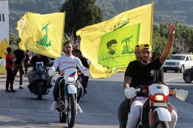 Supporters of Lebanon's Hezbollah leader Sayyed Hassan Nasrallah, gesture as they ride in a convoy, marking the commemoration of Israel’s withdrawal from southern Lebanon in 2000, in Kfar Kila village, near the border with Israel, southern Lebanon, May 25, 2022.  REUTERS / Aziz Taher