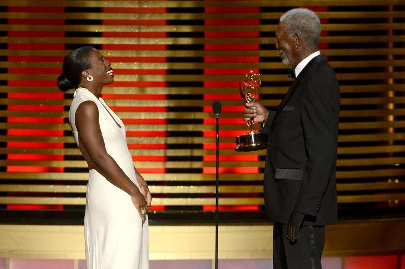 Morgan Freeman, right, presents the award for outstanding guest actress in a comedy series on stage to Uzo Aduba for her work on Orange Is the New Black at the Television Academy’s Creative Arts Emmy Awards. Phil McCarten / Invision for the Television Academy / AP Images