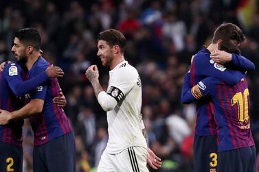 FILE PHOTO: Soccer Football - La Liga Santander - Real Madrid v FC Barcelona - Santiago Bernabeu, Madrid, Spain - March 2, 2019 FC Barcelona's Lionel Messi, Luis Suarez and Gerard Pique celebrate victory as Real Madrid's Sergio Ramos walks off REUTERS/Sergio Perez/File Photo