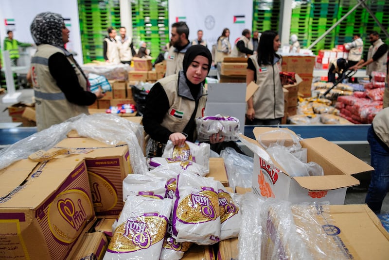 Volunteers from Emirates Red Crescent prepare parcels with humanitarian aid for Gaza. Reuters