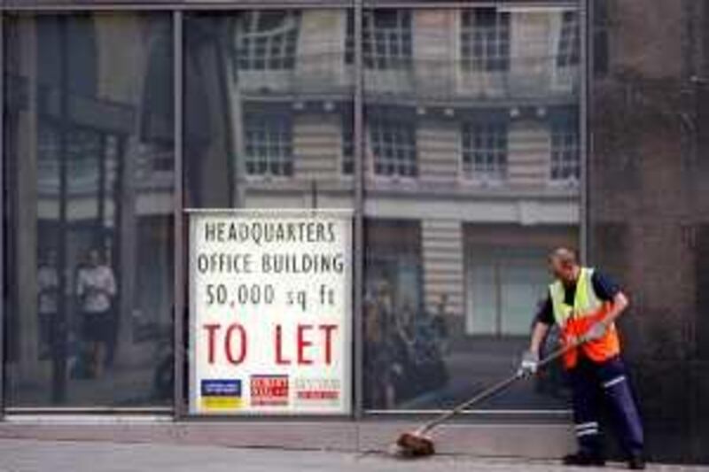 A street cleaner sweeps the pavement outside a building with a sign for office space "To Let" in its window, in central London June 30, 2009. Britain's economy will return to growth later this year, despite data on Tuesday that showed a sharper than expected fall in output in the first quarter, Treasury Minister Liam Byrne said. The Office for National Statistics said earlier GDP fell by 2.4 percent in the first quarter, revised down from a fall of 1.9 percent.     REUTERS/Andrew Winning   (BRITAIN BUSINESS)