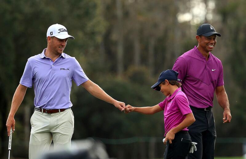 Charlie Woods high fives with Justin Thomas on the ninth hole. AFP