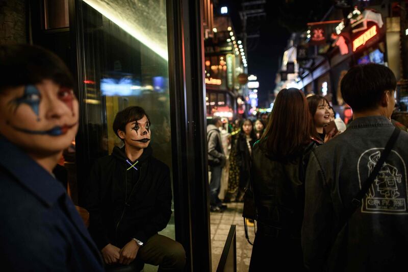 Revellers wearing Halloween make-up sit in a bar in the popular nightlife district of Itaewon in Seoul.  AFP