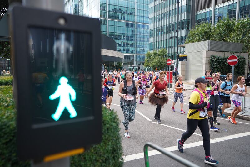 Runners make their way through Canary Wharf during the TCS London Marathon in October. PA