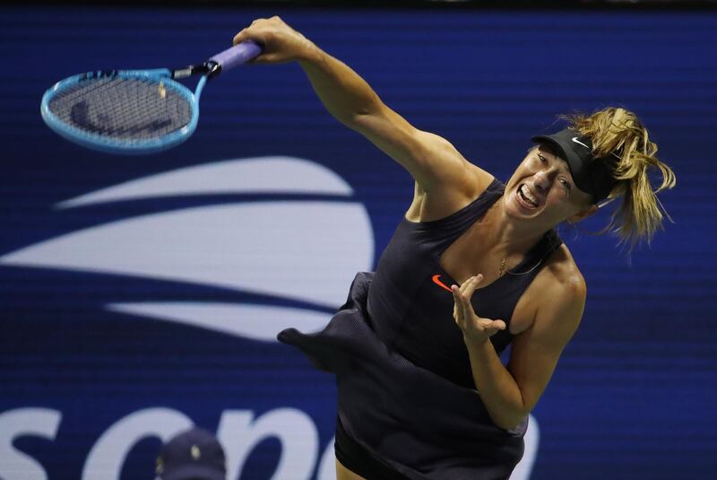 Maria Sharapova serves to Serena Williams. EPA