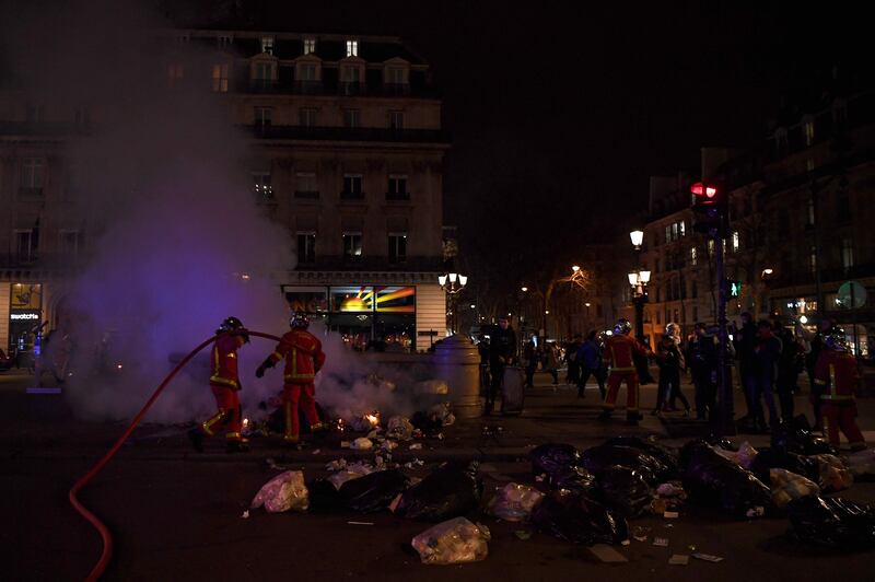 Firefighters extinguish a blaze at the Place de l'Opera on Monday night. AFP