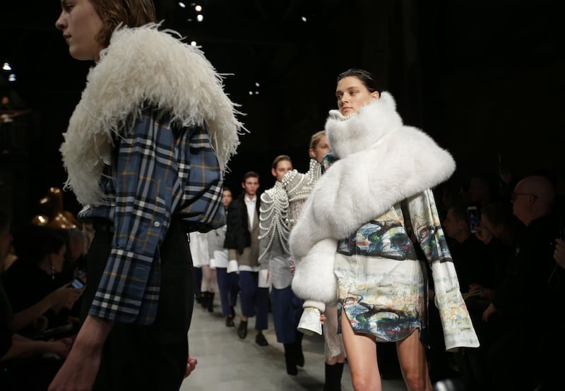 (FILES) In this file photo taken on February 20, 2017 models present creations from the Burberry collection during a catwalk show on the fourth day of the Autumn/Winter 2017 London Fashion Week in London. - British luxury fashion group Burberry has stopped burning unsold products and will no longer use real fur and angora in its clothes, chief executive Marco Gobbetti revealed on September 6, 2018. (Photo by Daniel LEAL-OLIVAS / AFP)